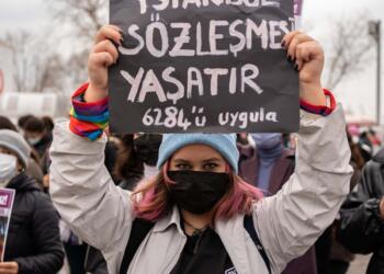 People attend a protest organized by feminist organizations and LGBTQI activists against Turkey’s withdrawal from the Istanbul Convention seen in Istanbul, Turkey on March 20, 2021. According to a presidential decree published on Saturday, Turkey withdrew from Istanbul Convention, a treaty on preventing violence against women and domestic violence which was signed in 2011. The sign translates as 'Istanbul Convention lets us live. Apply the 6284'.  (Photo by Erhan Demirtas/NurPhoto)
