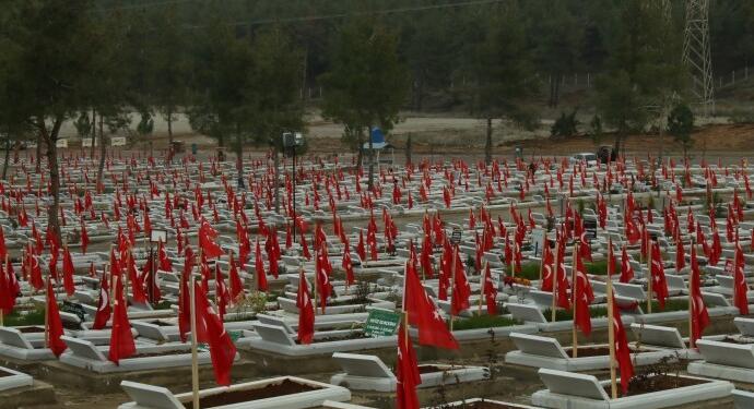 Depremde unuttukları insanların mezarına bayrak diktiler